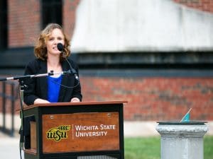 Morgan Barnes, professional services manager for the Public Policy and Management Center, speaks at the rededication ceremony for a sundial that was donated to Wichita State in 1934. The sundial was dedicated to the late Dr. George Platt, professor emeritus at the Hugo Wall School of Public Affairs, and is located on the east side of Hubbard Hall.