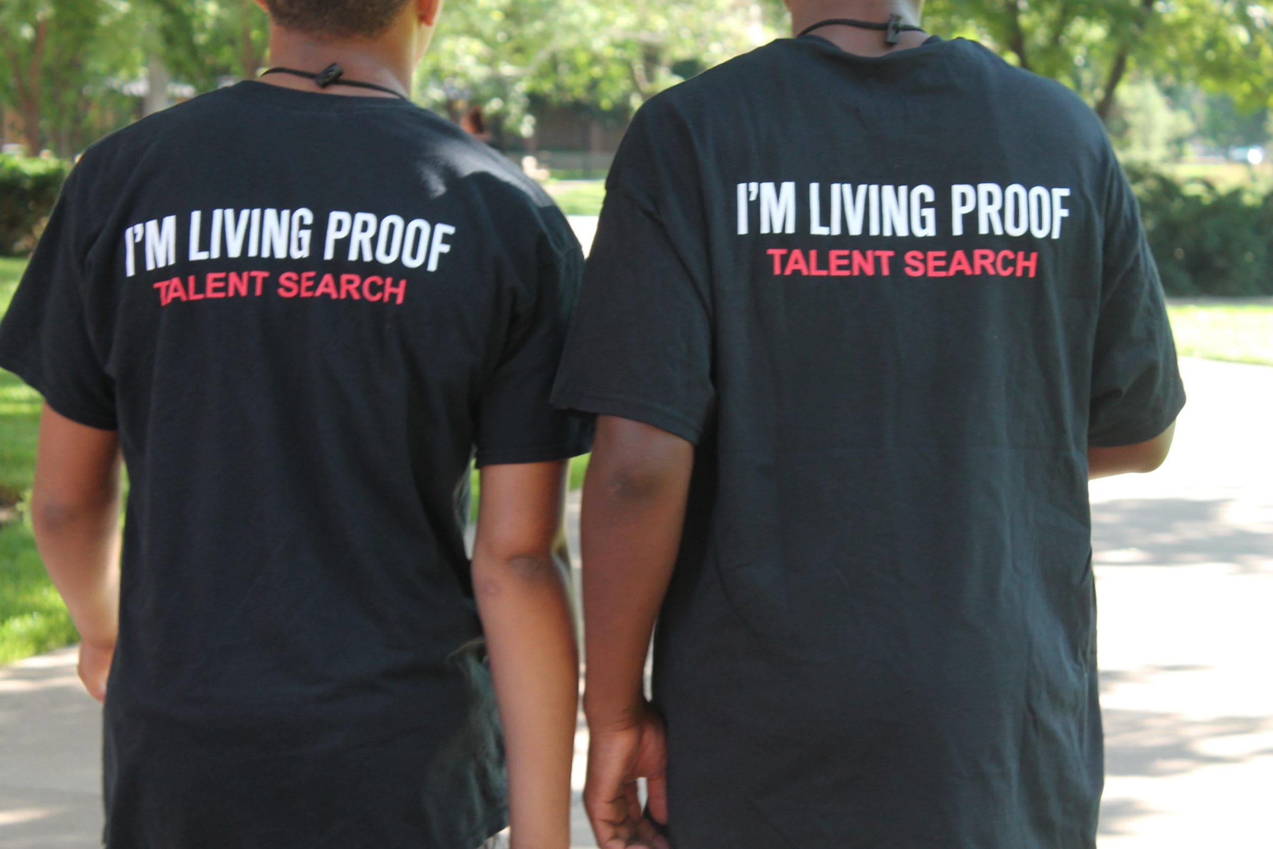 2 boys wearing shirts that state: I'm Living Proof- Talent Search on the back
