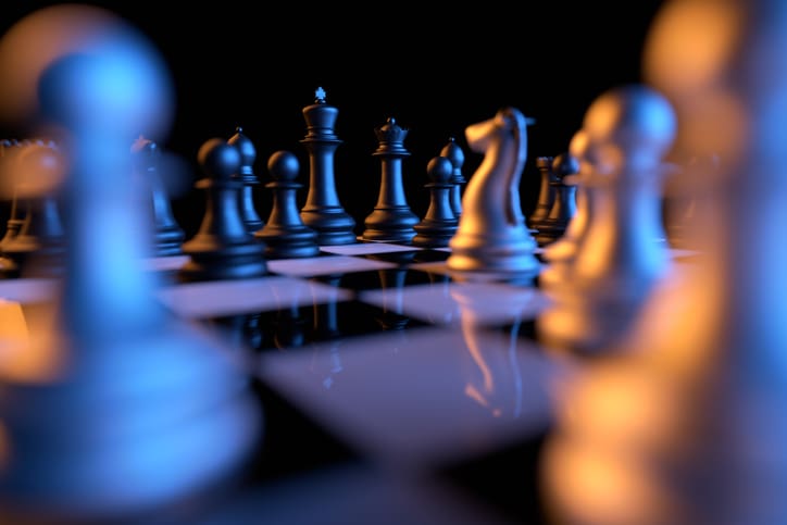 Close up of chessmen on chessboard with the focus on a queen