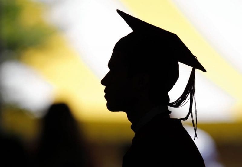 A headshot of a college graduate in silhouette.
