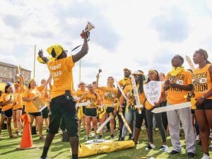 Wichita State students gather before an event on a field.