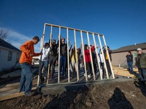 President Rick Muma and First Gentleman Rick Case help Wichita Habitat for Humanity members raise wall.