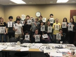 Picture of Students showing off their calligraphy at the 2020 Japan Festival at RSC.