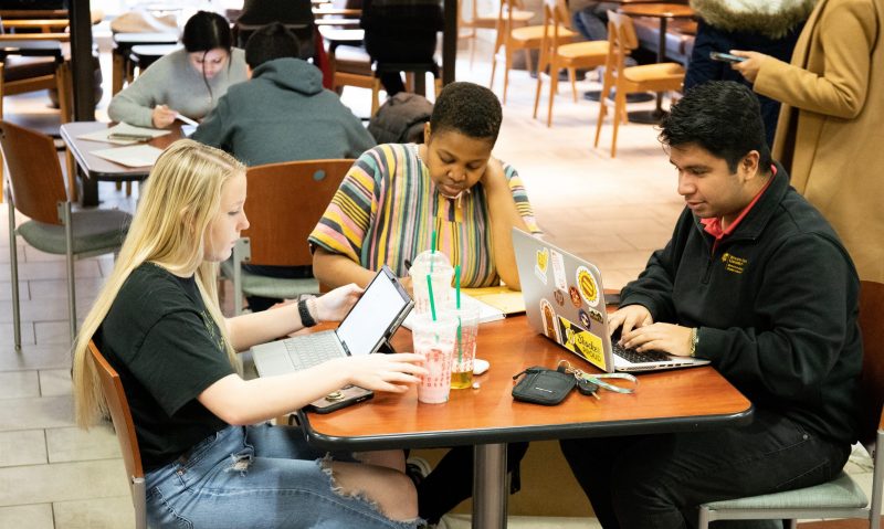 Picture of five students sitting at tables at Fairmont College.