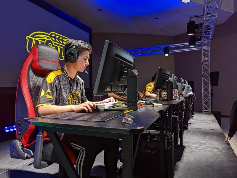 Wichita State University's Truman Nguyen is sitting at a computer in The Hub room representing the Esports team for the videogame, Valorant