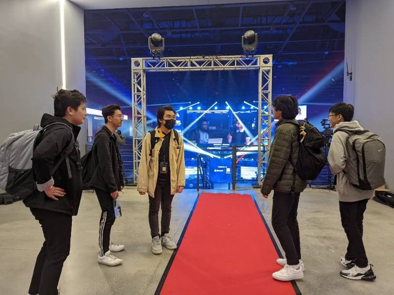 Esports students standing near red carpet