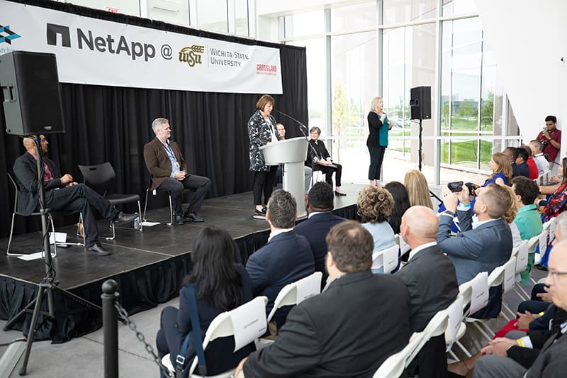 Image of faculty and state leaders on stage at NetApp grand opening.