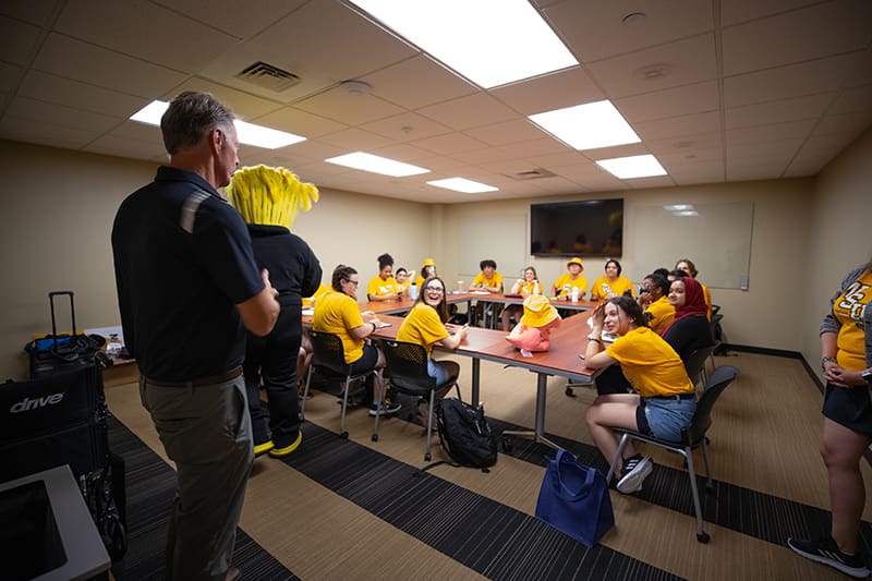 Wu and Rick Case surprise staff members of Orientation and Undergraduate Admissions at their office.