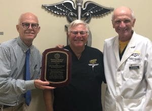 Dr. Elledge, Dr. Evans and Dr. May pose with the 2022 Sandra Mitchell Memorial Award for Community Service.