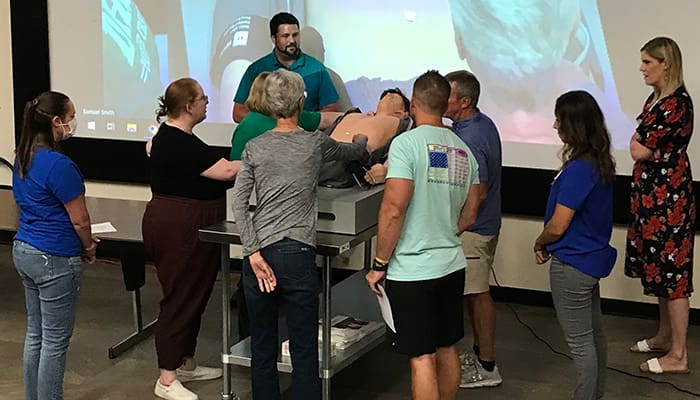 Health science teachers work with the new Harvey simulation manikin during the High School Health Science Teacher's Workshop.