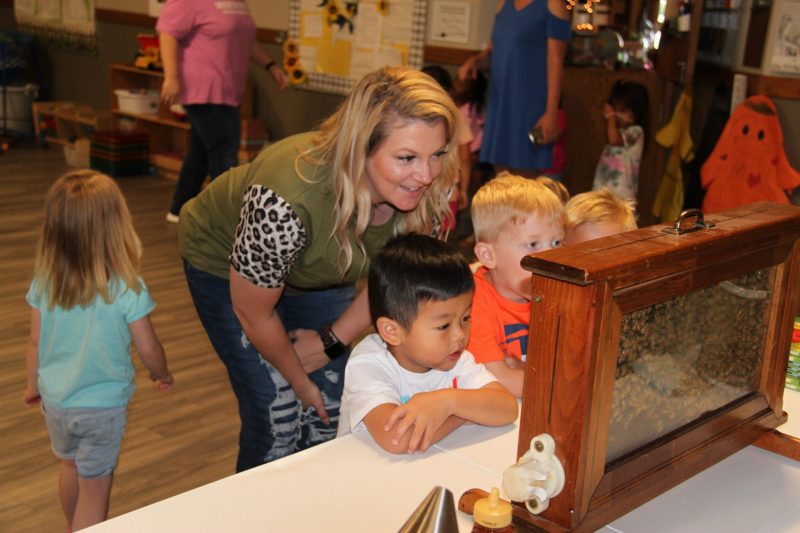 Image of teacher with Picture of teacher with students.