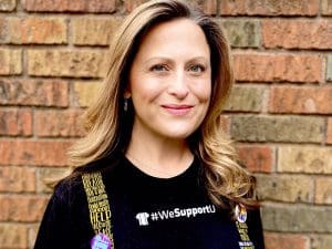 Headshot of Dr. Jessica Provines wearing Suspenders4Hope T-shirt.