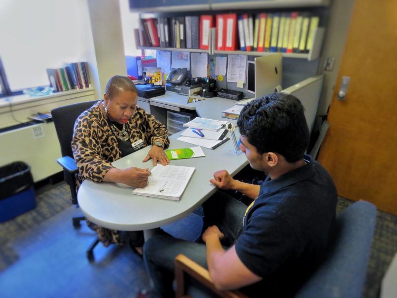 Image of Student receives academic instruction from teacher.