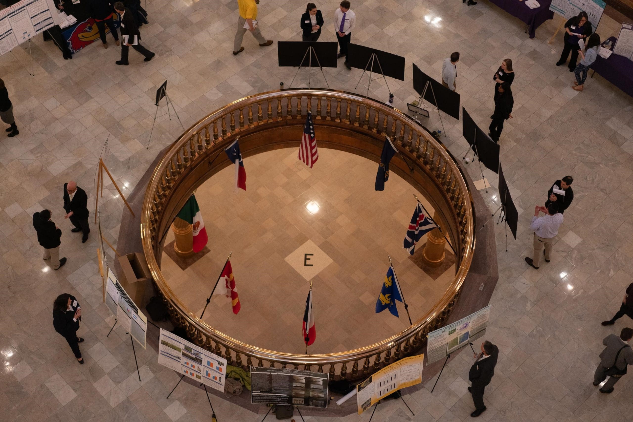 Photo of graduate students presenting their research at the Capitol Rotunda.
