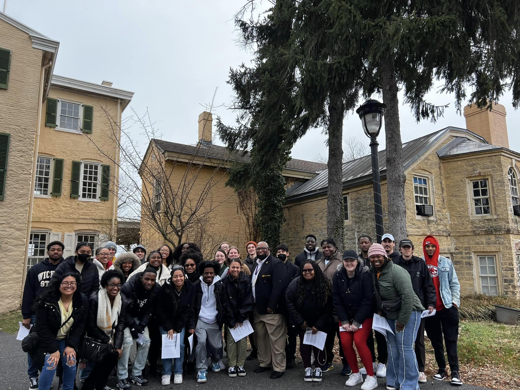 A photo of 31 students and staff members standing in front of building for their civil rights trip.