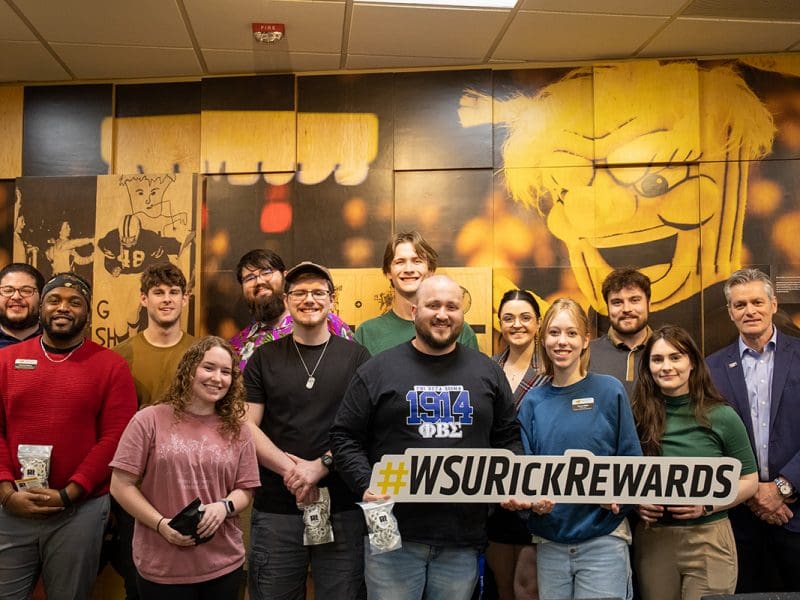 A photo of the Student Government Association with President Rick Muma holding up the Rick Rewards sign.