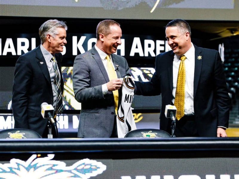 Photo of President Rick Muma, new men's basketball coach Paul Mills and Director of Athletics Kevin Saal at Thursday's introduction event.