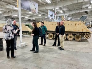 Photo of members of WSU NIAR and the Army GVSC touring military vehicles.