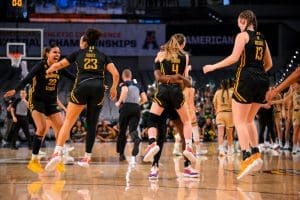 Photo of the Shocker women's basketball team celebrating the win against USF on March 7.