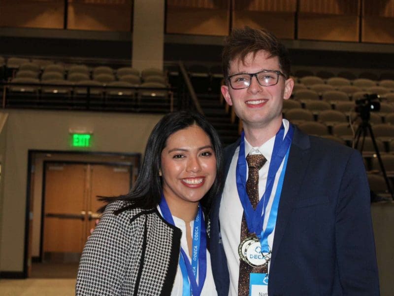 Photo of Jennifer and Nathan with their DECA medals.