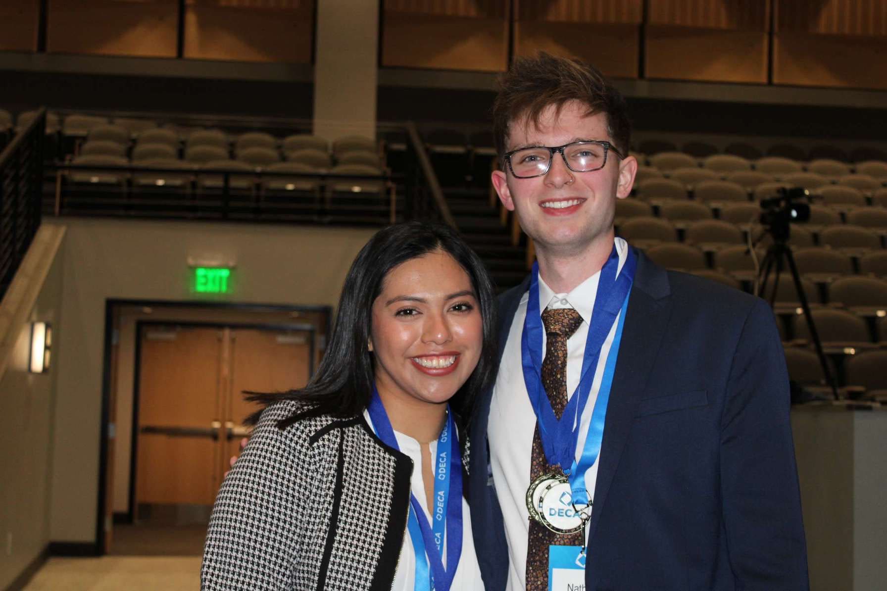 Photo of Jennifer and Nathan with their DECA medals.