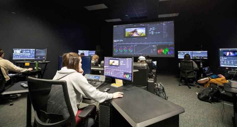 Photo of students editing videos on computers in Shocker Studios.