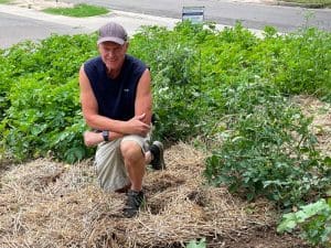 First Gentleman Rick Case poses among the fruits and vegetables in the community garden at College Hill United Methodist Church in Wichita