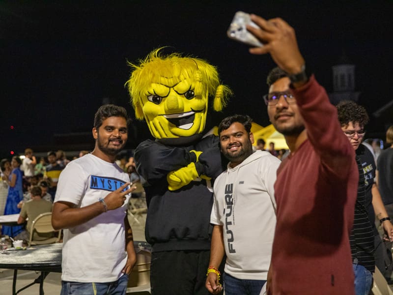 Students take a selfie with Wu during a night event