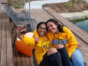 Two students take a selfie on campus
