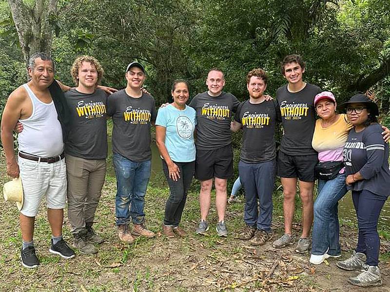Students in the Engineers without Borders program pose with the local community in Ecuador