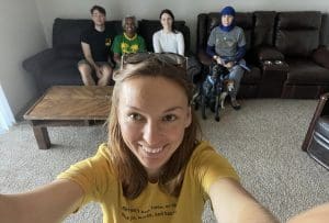 A volunteer takes a selfie with Wichita-based refugees from other countries.