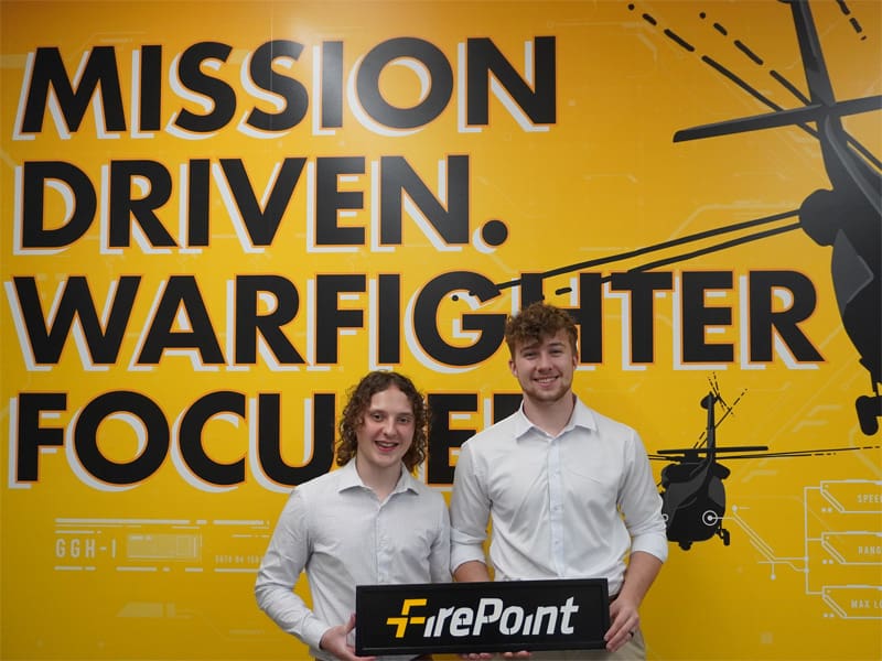Greg Heiman and Murphy Ownbey holding a FirePoint sign