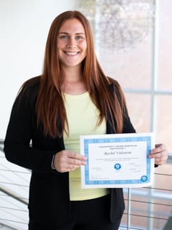 Rachel Valentine holding her Certified Career Services Provider certificate