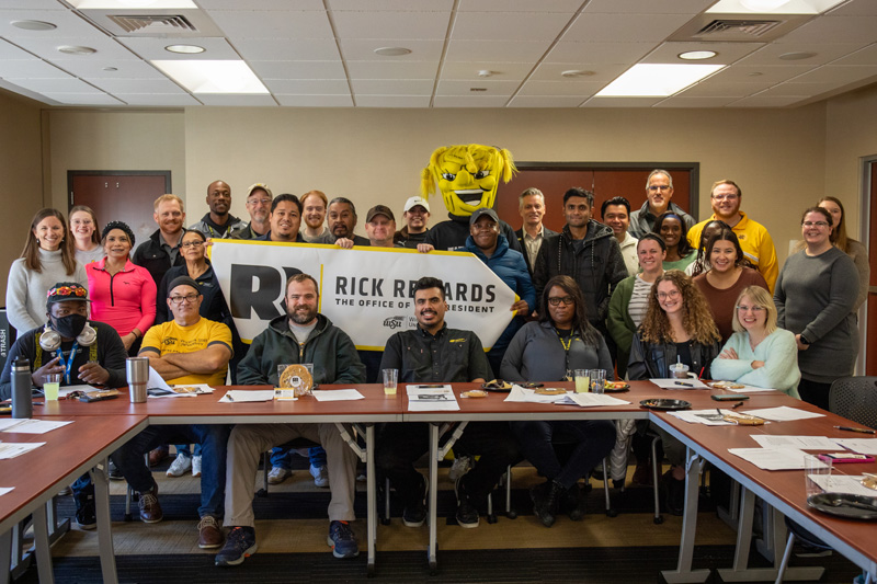 President Rick Muma and WuShock pose with the staff from Housing and Residence Life for Rick Rewards