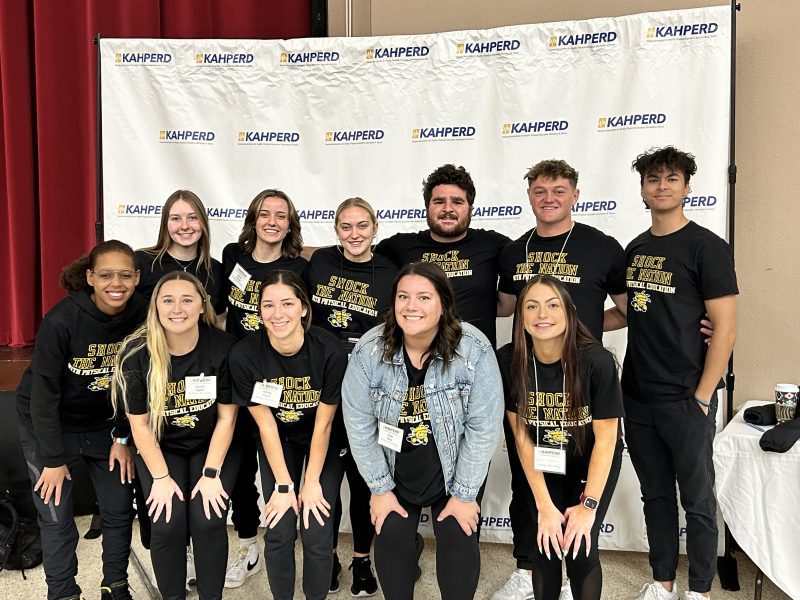 Students from WSU's physical education program pose for a photo at the KAHPERD convention at Century II in Wichita, KS.