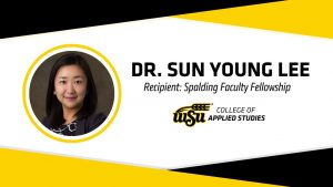 White background with black and yellow elements on the top and bottom with circular photo of Dr. Sun Young Lee with text: Dr. Sun Young Lee, Recipient: Spalding Faculty Fellowship, College of Applied Studies Logo