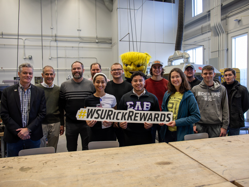 President Rick Muma and Wu pose with students from the Project Innovation Hub for Rick Rewards