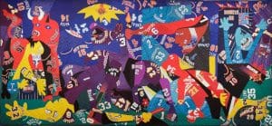 A quilt constructed of sports jerseys by artist Hank Willis Thomas is pictured. This piece is called Guernica.