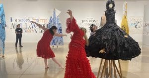 Dancers perform among works of art in a gallery.