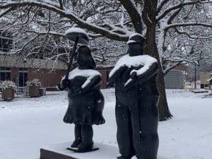 Statues on campus in the snow