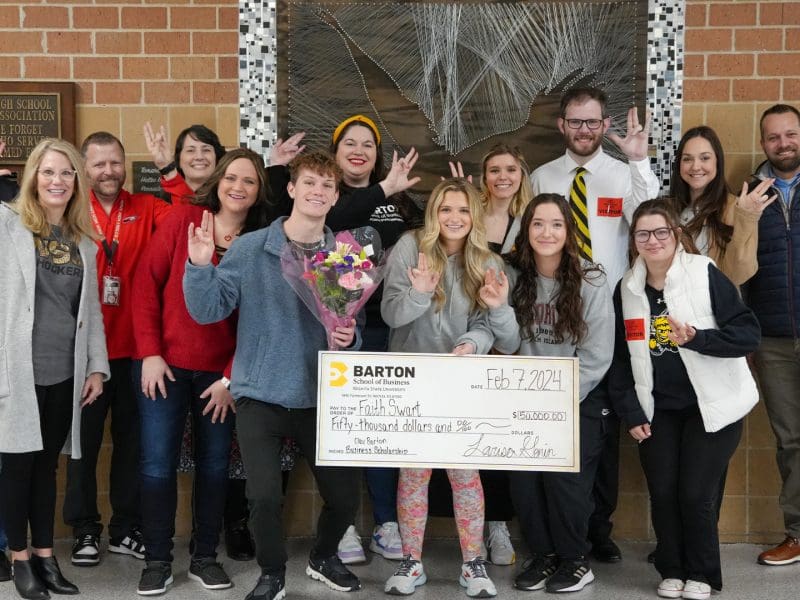 Faith Swart, the latest recipient of the Clay Barton Business Scholarship, poses with friends, family, Maize High School staff, and a contingent from the Barton School of Business and Wichita State University.