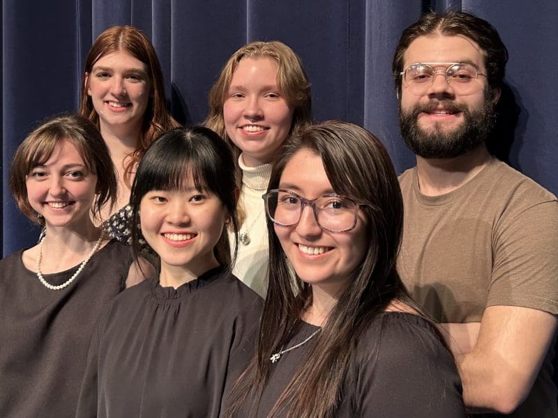 Six student soloists are pictured smiling at the camera. L to R: Grace Stringfellow, Josephine Barstad, Anne Yap I-Shyuen, Aria Beert, Karla Lugo, Luis Gomez.