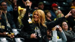 Shocker fans holds young child while cheering at a recent game