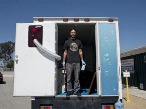 David Emitt Adams standing in the back of a truck.