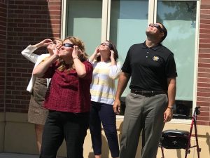 Shockers watching an eclipse with eclipse glasses