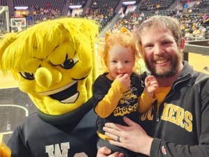 Zachary Brown with his daughter and WuShock in Charles Koch Arena