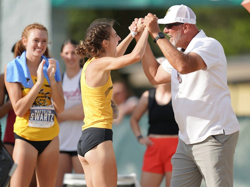 Marissa Jensen, WSU high jumper, celebrates with Steve Rainbolt, director or track and field, during a competition