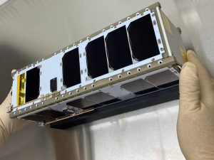 The CubeSat sits in a laboratory