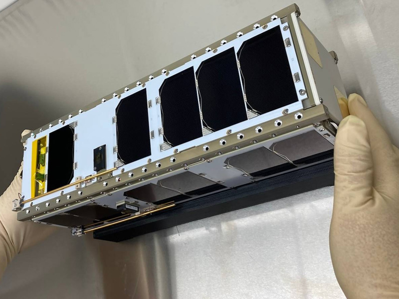 The CubeSat sits in a laboratory