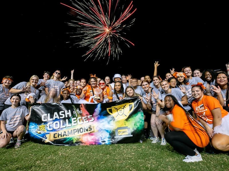 College of Health Professions' students pose for a group photo with the Clash of the College's championship trophy and banner.